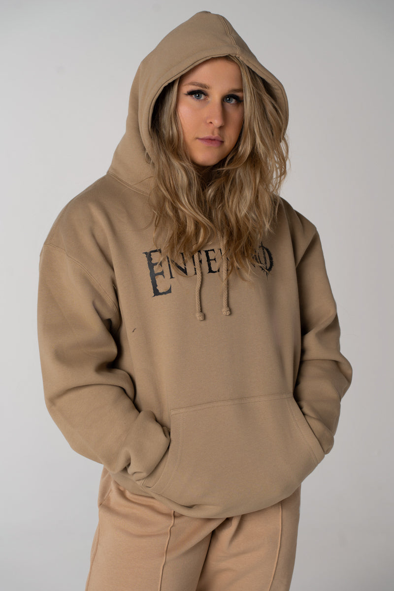 Model wearing Enferno Classic Logo Heavyweight Hoodie in Sandstone.