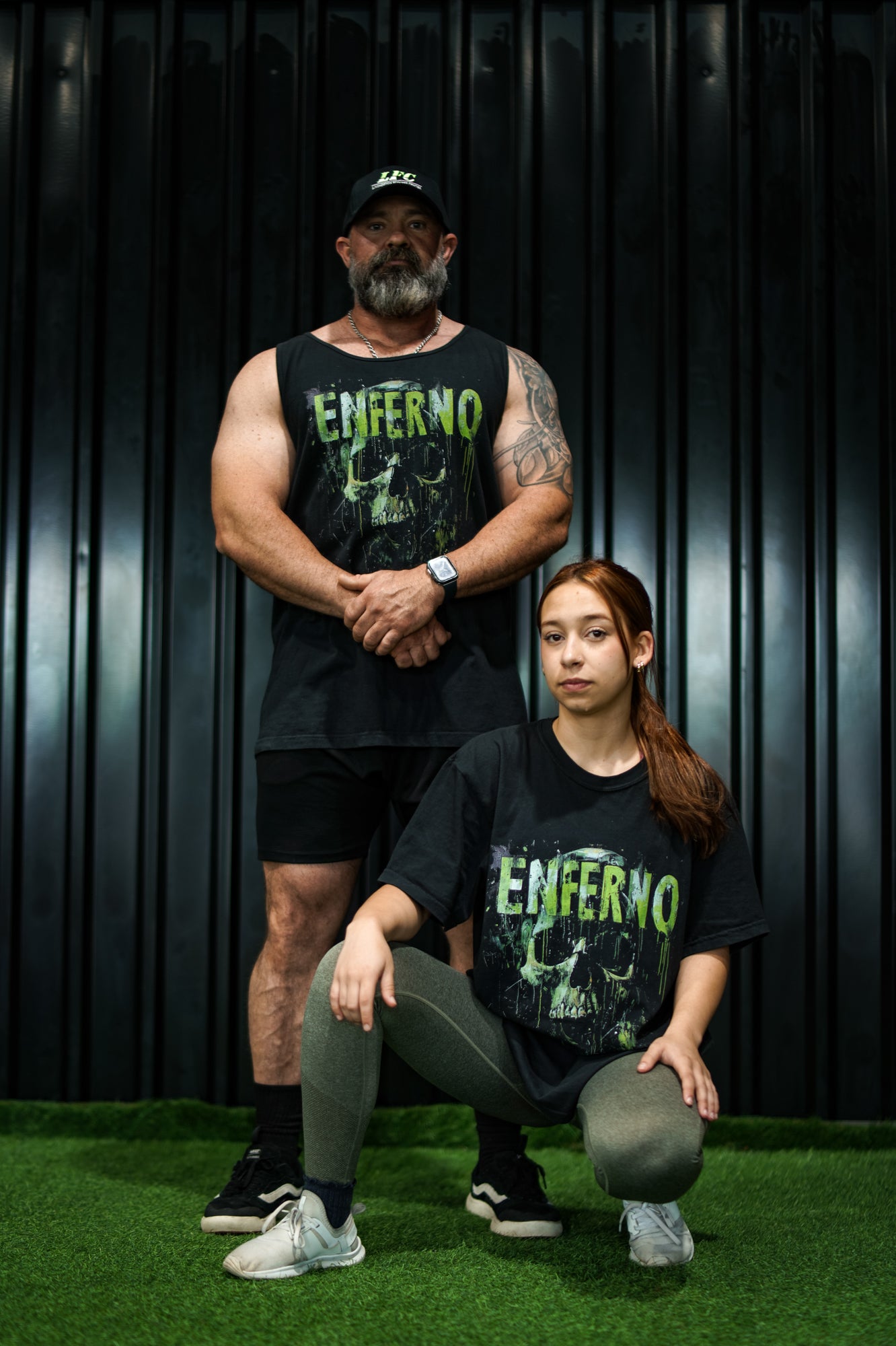 Enferno Emerald Skull Tank in Black on model Grady. Enferno Emerald Skull Tee in Black on model Madelyn.