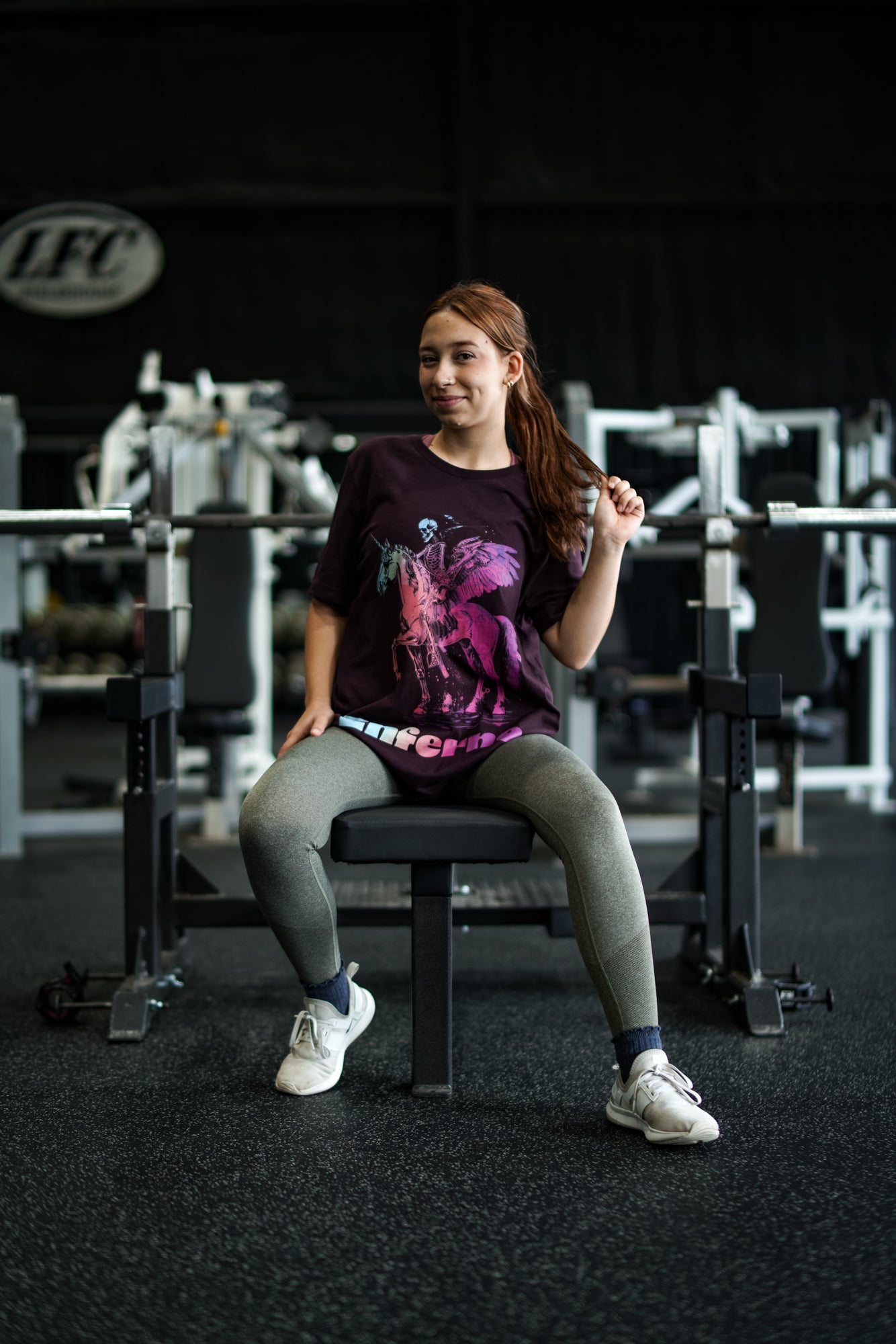 Enferno Death on a Rainbow Band Tee in Oxblood Black on model Madelyn.
