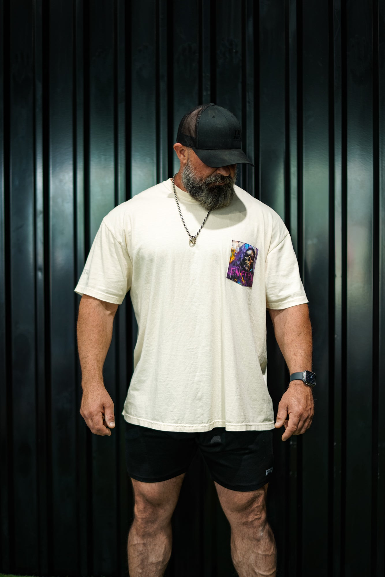 Enferno Diet Face Pocket Tee in Ivory on model Grady.