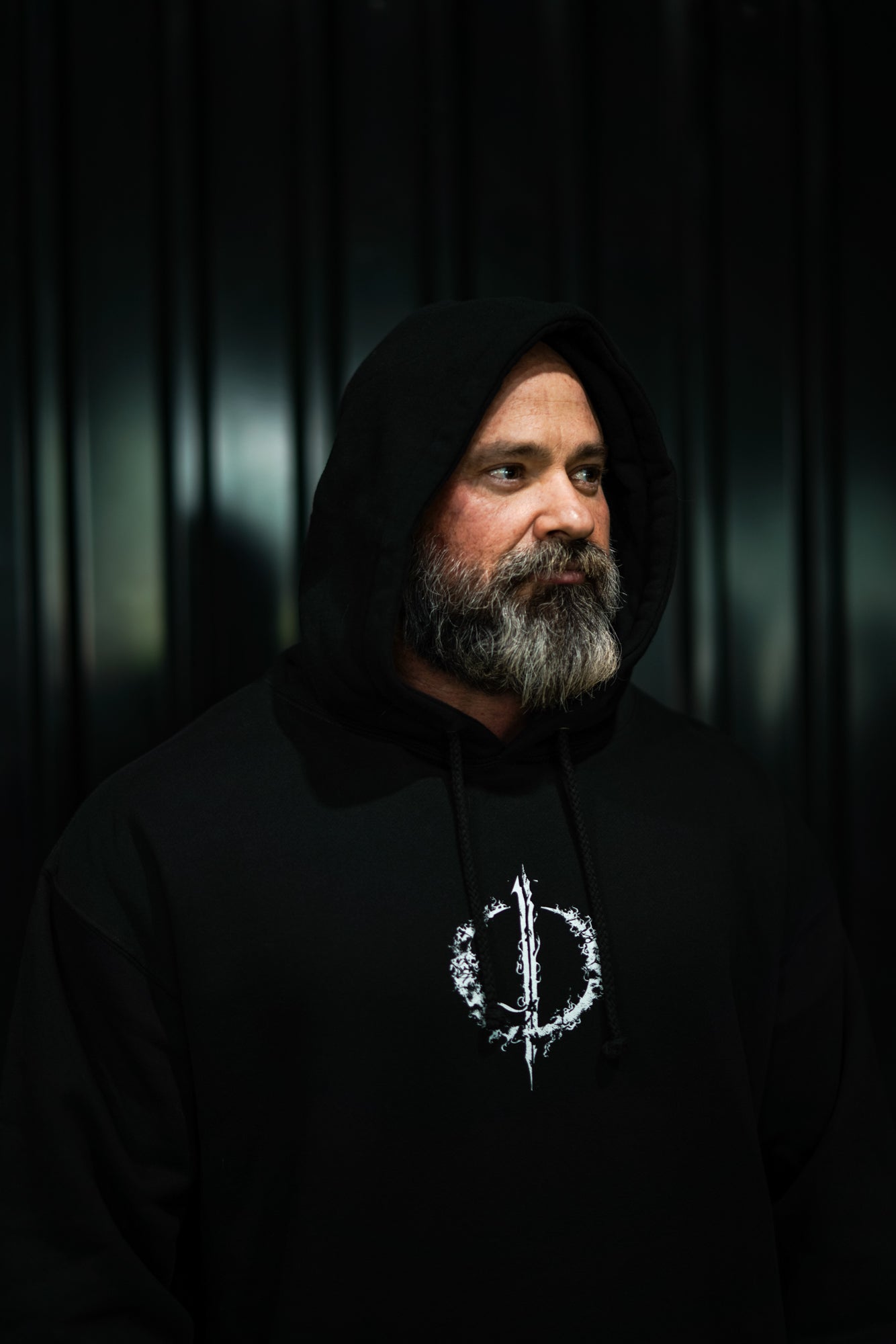 Enferno Back Repeat Hoodie in Black on model Grady.