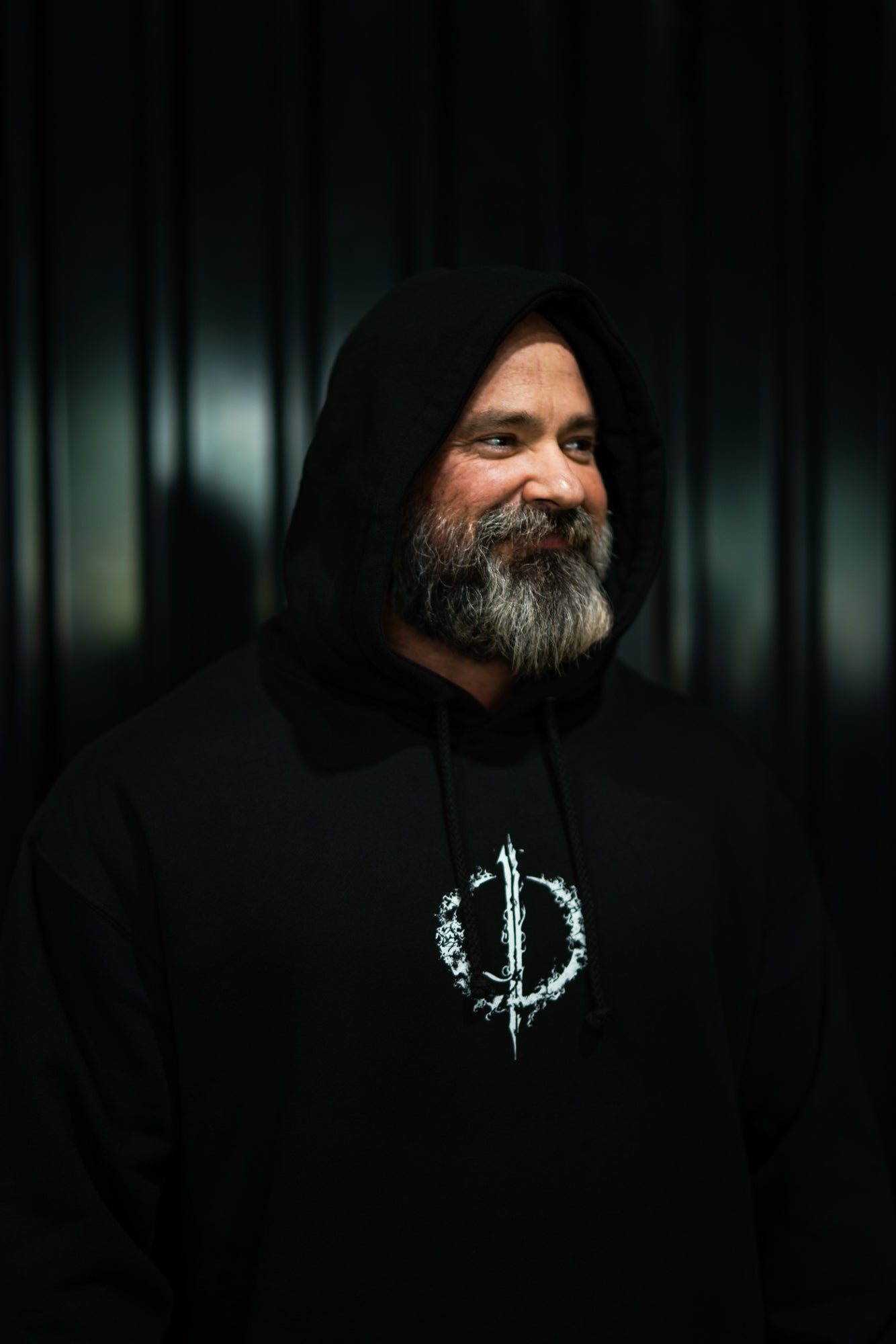 Enferno Back Repeat Hoodie in Black on model Grady.