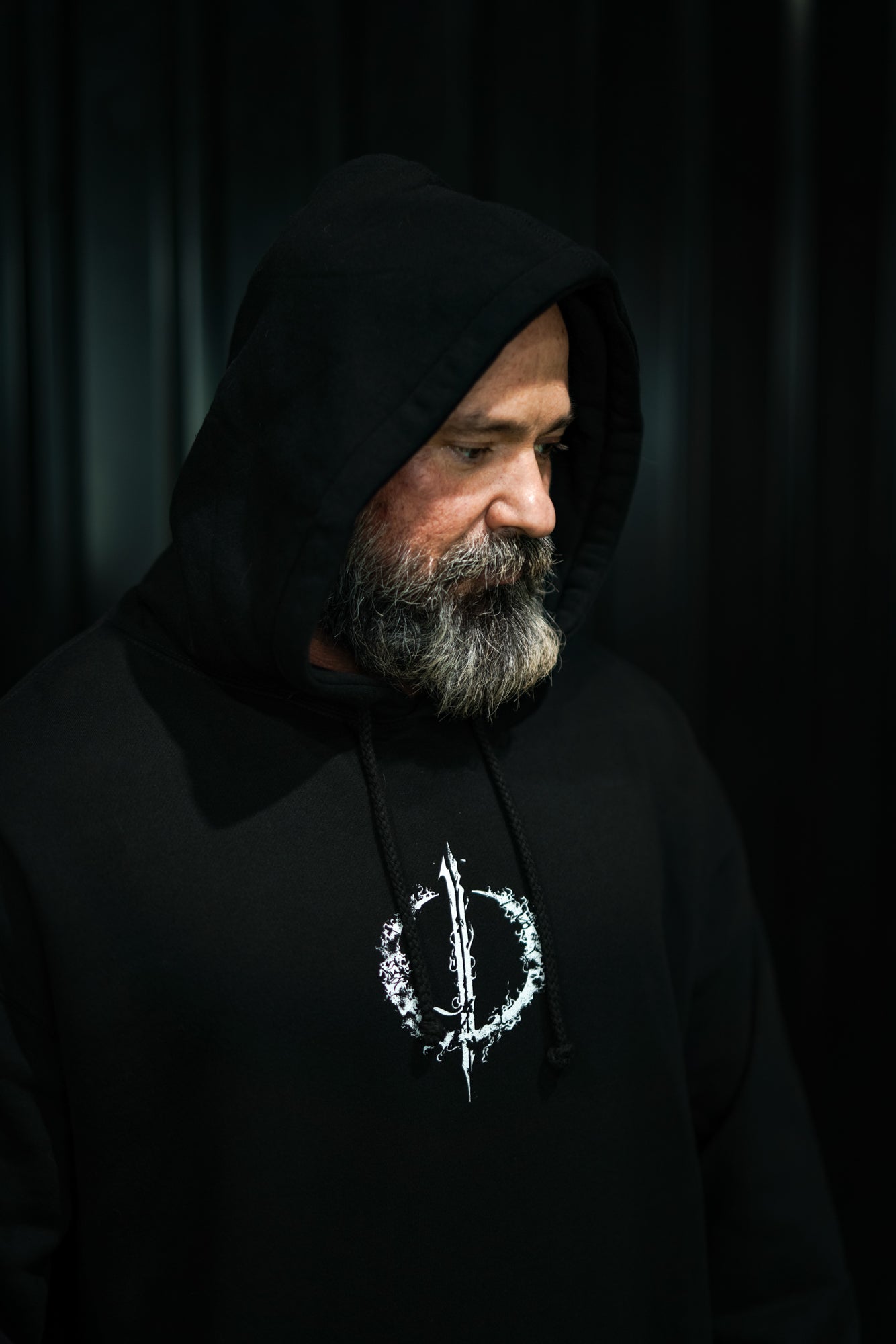 Enferno Back Repeat Hoodie in Black on model Grady.