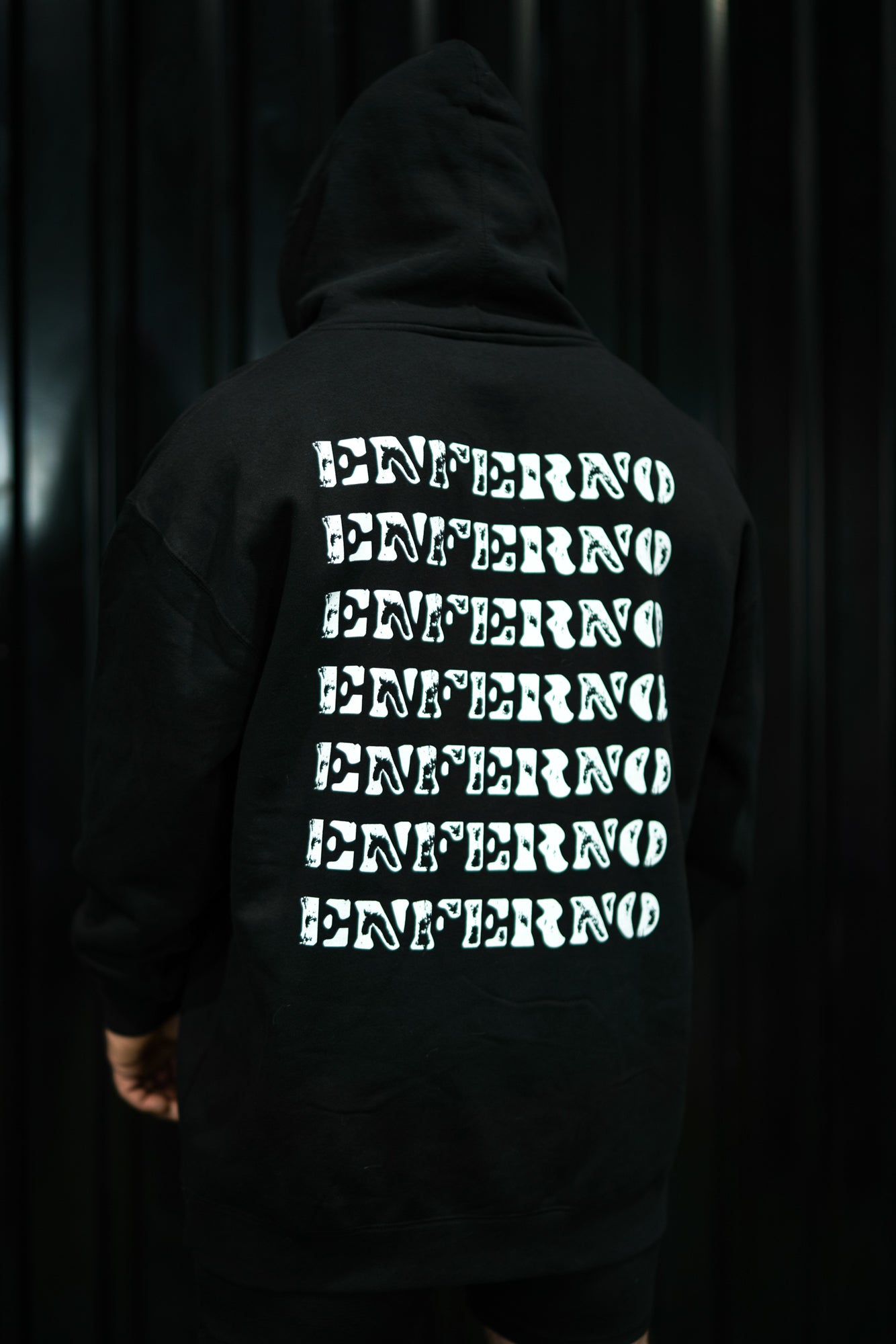Enferno Back Repeat Hoodie in Black on model Grady.