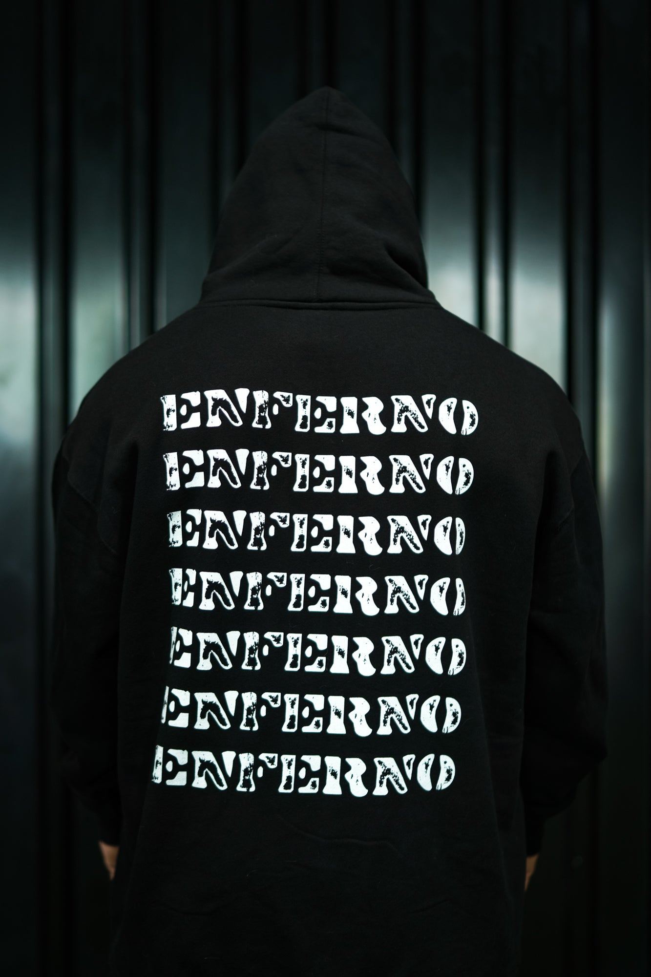 Enferno Back Repeat Hoodie in Black on model Grady.