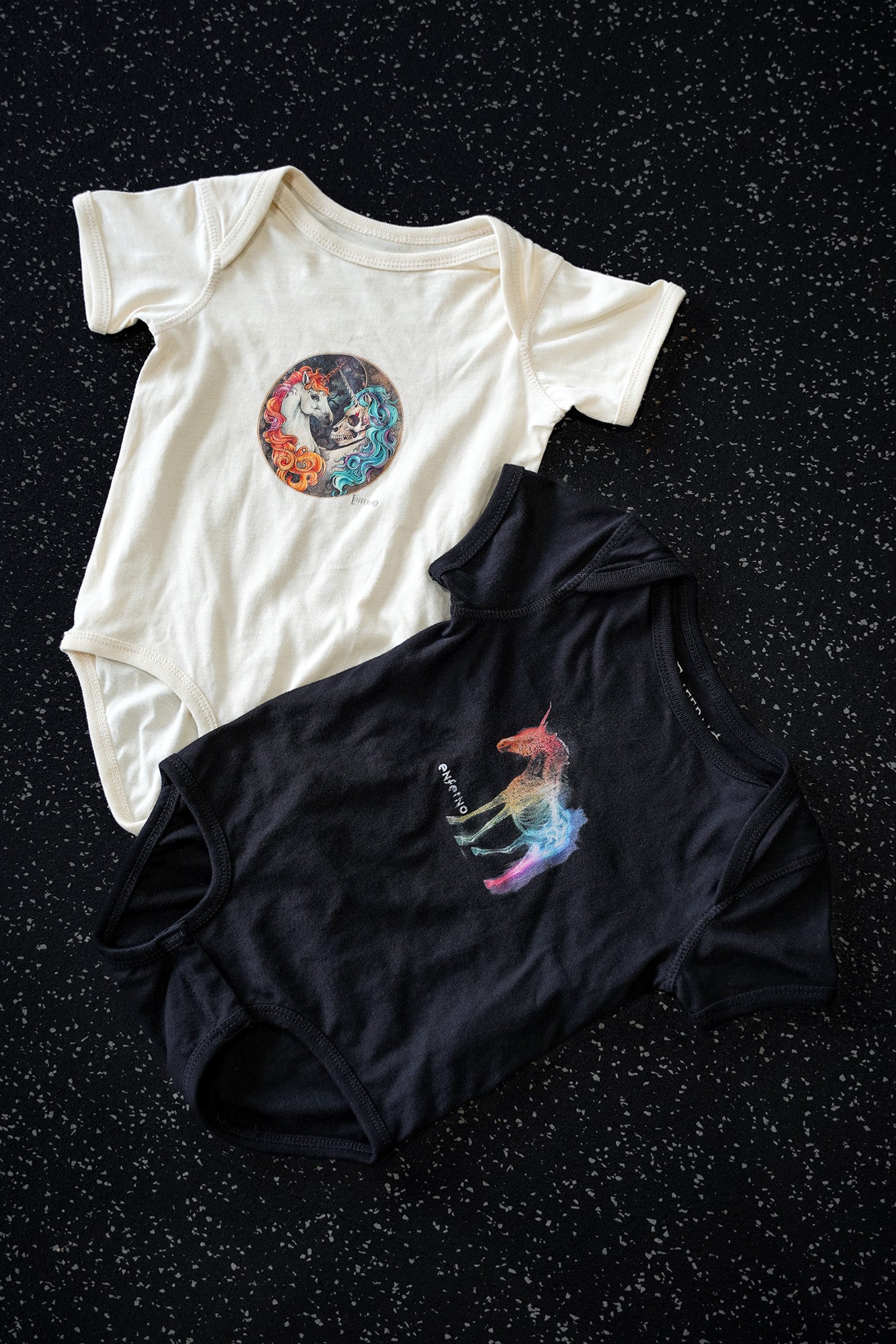 Enferno Yin-Yang Unicorn Onesie in Natural with Enferno X-Ray Unicorn Onesie in Black.